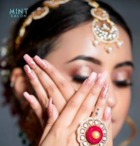 Close-up of beautifully designed nail art with glossy finish at Mint Salon