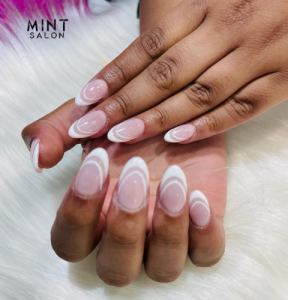 Client enjoying a relaxing pedicure at Mint Salon’s clean and cozy nail lounge